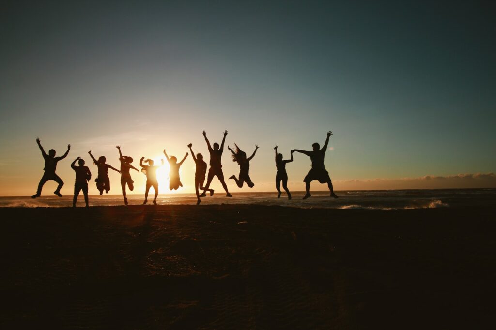 silhouette photography of group of people jumping